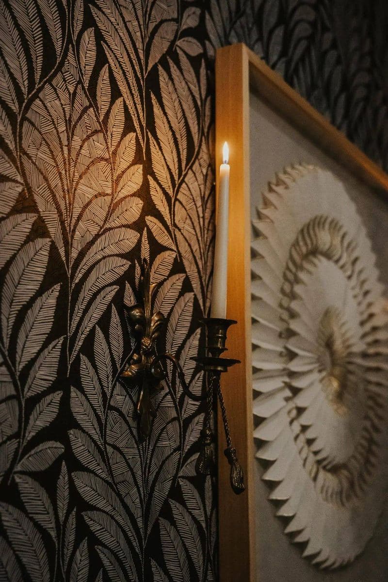 Enhance Aesthetics office interior — IV lounge detail with botanical wallpaper and candle